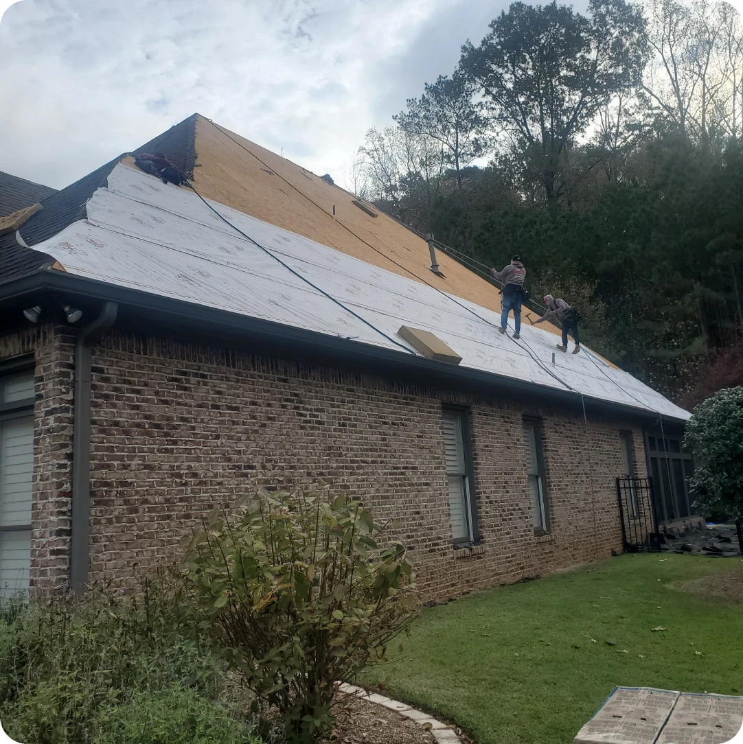 Workers installing new roof covering